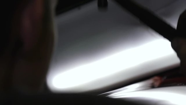 The guy knocks with a hammer on the car to align the dent on technology PDR. Paintless Dent Repair Removal. Reflective surface, car, auto repair shop. Tap Down Tools Dent Rubber Hammer Auto Body