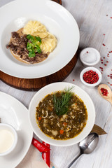 Hot rustic sorrel soup as a part of diet set menu in a restaurant