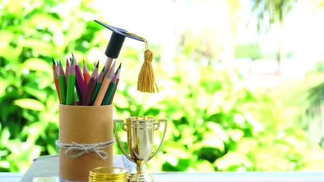 Graduate study or education knowledge is power concept: Graduated cap put on color pencils in basket. Conceptual for educational is successs learning abroad international or business. Back to School