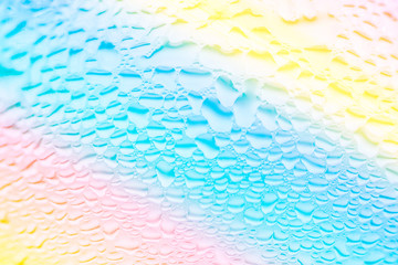 Trendy liquid texture background. Transparent water rain drops patterns on glass. Gradient rainbow pastel colors. Abstract backdrop. Template for design. Technology nature environment concept