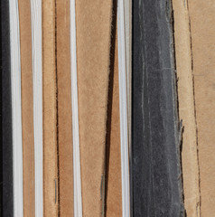 Row of used and worn notebooks, closeup