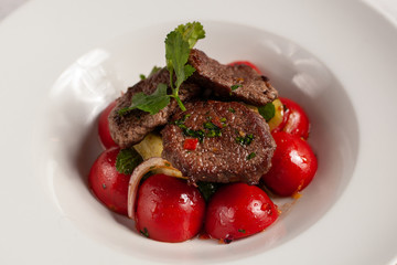 Close up of mini steaks with mashed potatoes and onion, served on white plate