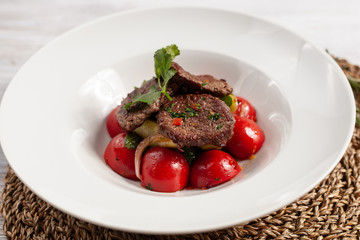 Close up of mini steaks with mashed potatoes and onion, served on white plate