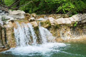 Fototapeta na wymiar Caucasian mountains. Waterfall on the mountain river Zhane.