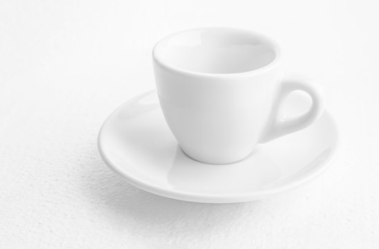 white coffee cup and saucer, empty coffee-free coffee cup, front view from above, or black coffee, on a white background,copy space