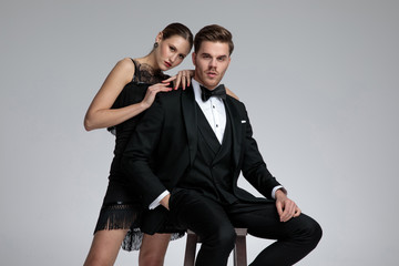 Determined young man sitting while his girlfriend leans on him