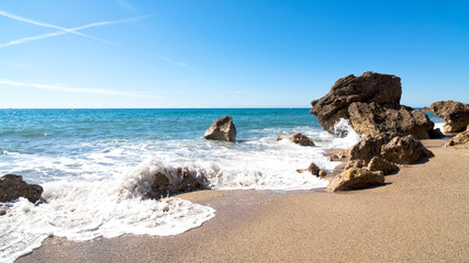 Beautiful deserted beach and huge rocks on the background. Miami Platja, Costa Dorada Coast, Tarragona, Spain
