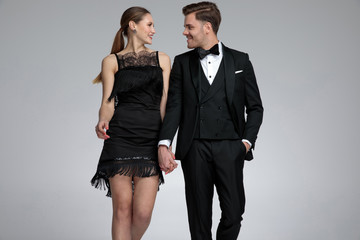 Happy young couple holding hands and laughing