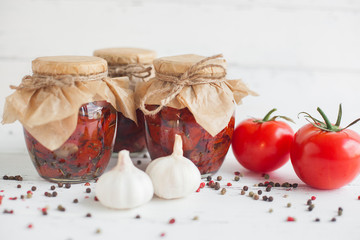 Tomatoes in the jar. Homemade sun dried tomatoes. temporary closing-down. Summer and autumn canned food. conserve with spices and vegetables.