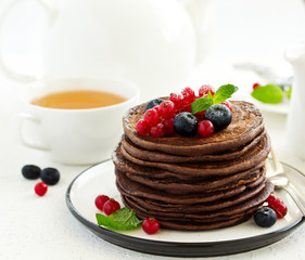 Chocolate pancakes with berries.