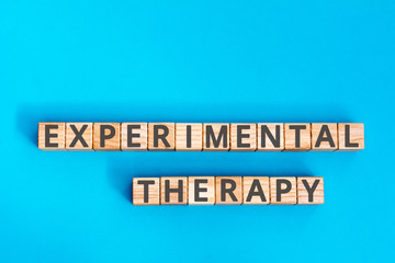 experimental therapy inscription wooden cubes with letters on  blue background