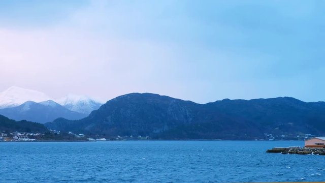 Leinoya, Norway. View of the mountains of Leinoya island in Norway during the coudy day. Small village at the shore.