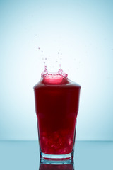 Splash on a glass of  raspberry juice representing the concept of without spilling a drop