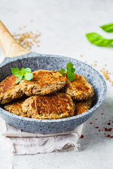 Lentil cutlets in gray frying pan. Healthy vegan food concept.