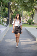 Obraz premium Portrait of thai adult student university uniform beautiful girl relax and smile