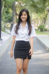 Obraz premium Portrait of thai adult student university uniform beautiful girl relax and smile