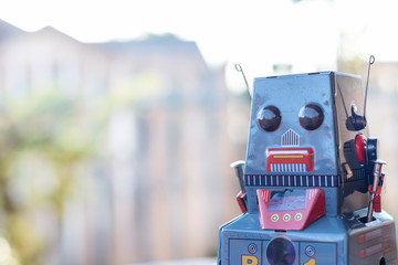 Antique tin toy robot on blurred background. Vintage and classic concept copy space for text.