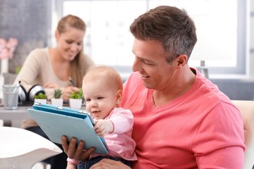 Obraz premium Happy baby reading e-book