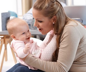 Mum and baby girl having fun