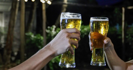 Asian group of friends having party with alcoholic beer drinks and Young people enjoying at a bar toasting cocktails and clinking glasses