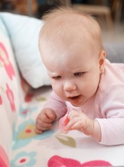 Baby playing with dummy
