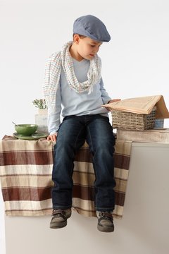 Little boy reading news on counter