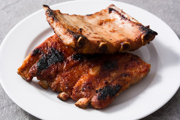 Grilled barbecue ribs on gray stone background