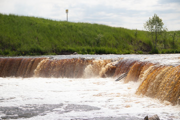 Sablinsky waterfalls. Little waterfall. The brown water of the waterfall.. Thresholds on the river....
