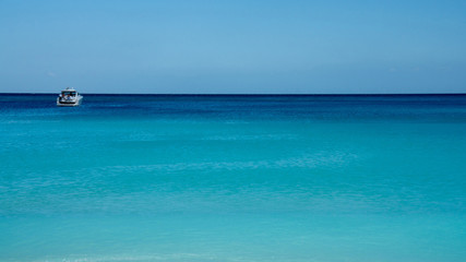 Fototapeta na wymiar Yacht in the Caribbean Sea turquoise color. Cancun, Mexico.
