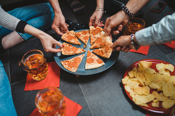 Group of friends eating pizza - Millennials have fun together - Day of happiness between young men...