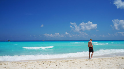 Tourist, Caribbean sea, sandy beach, Cancun, Mexico.