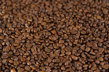 Roasted coffee beans on a table. Selective focus, high resolution