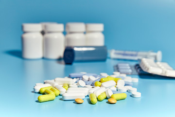 group of various medications on a blue background