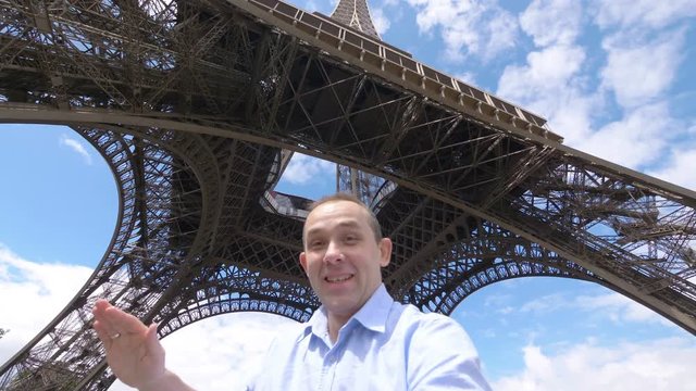 Man taking selfie with a view on Eiffel Tower in Paris in 4k slow motion 60fps