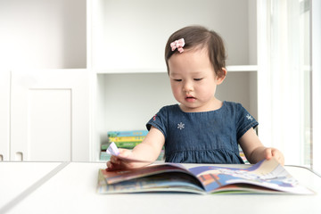 At home the girl sits at a desk and reads