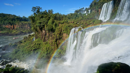 Iguazu Falls and a round rainbow on the Iguacu River. Located between Argentina and Brazil. Largest waterfalls system in the world.
