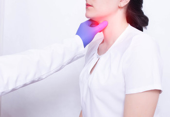 A specialist doctor diagnoses and examines a girl's sore throat, the presence of inflammation and...