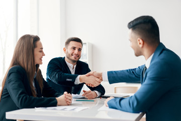 Business people shaking hands after good deal