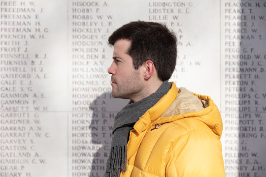 Man in front of Menin gate memorial wall