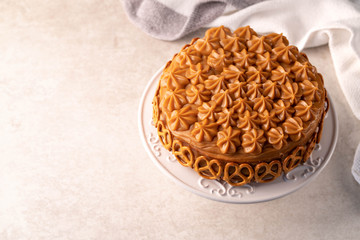 caramel cake on a white cake stand