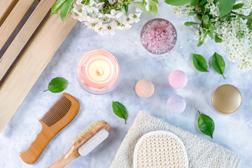 Spa and bath accessories with bath salts and beauty treatment products on white table. Wellness concept