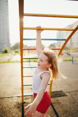 little girl has fun on monkey bar