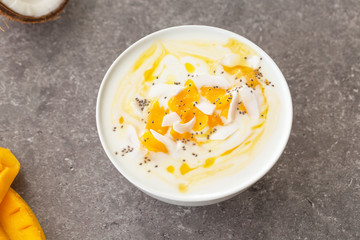 Mango smoothies bowl with coconut and Chia seeds. Vegan diet food concept. Healthy breakfast. 