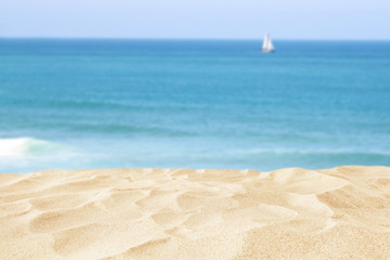 Empty sand beach in front of summer sea background with copy space