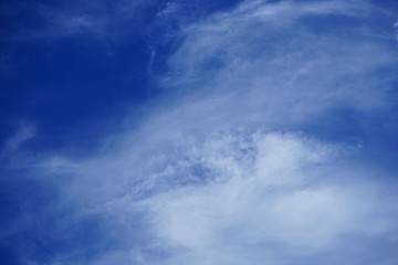 Brilliant Blue Sky with Clouds and the Moon