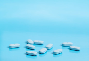 Blue medical pills on a blue background