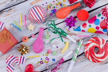 Fototapeta premium Colorful Birthday party items. Birthday accessories on wooden background. Preparation for kids party celebration.