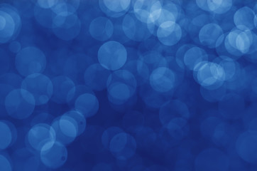 dark blue bokeh glitter sparkle abstract background.