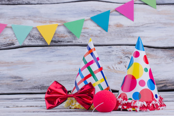 Party hats and other stuff on wooden background. Colorful decoration for Birthday party.