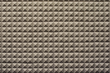 concrete wall texture stucco cement white and gray geometric seamless triangle pyramid background with shadow and light.